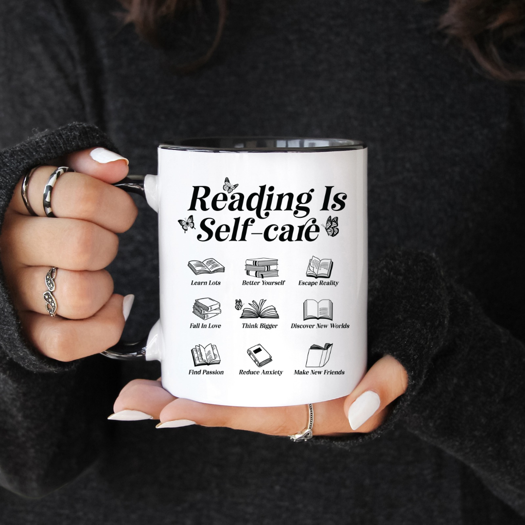 A person holding a white ceramic mug with black handle the text 'Reading is self-care' and various book-related icons on both sides.