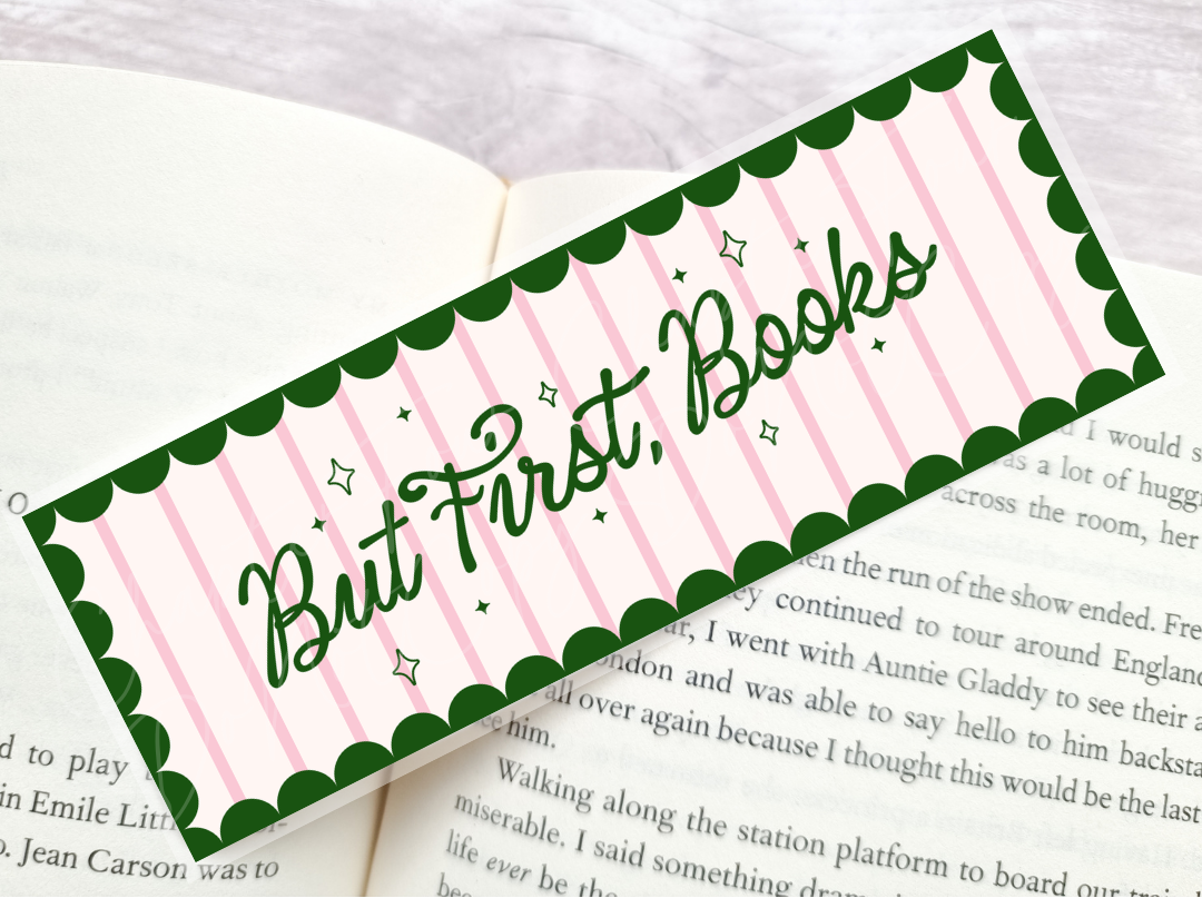 Bookmark with 'But First, Books' text laying on a book page