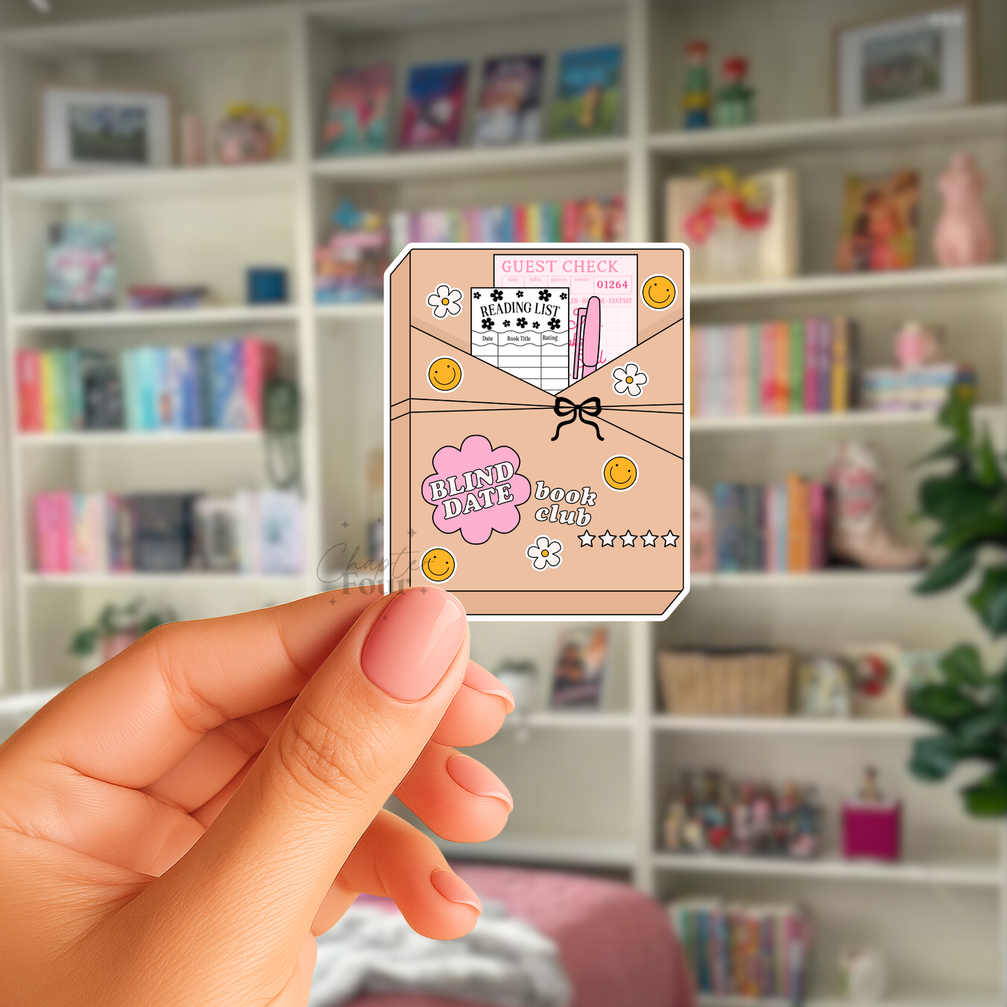 Hand holding a 'Blind Date Book Club' sticker in front of a bookshelf.