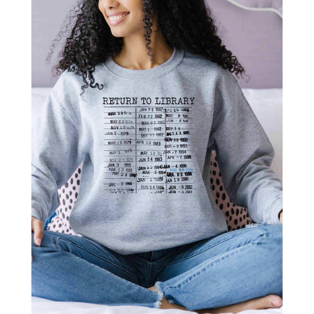 Sports Gray 18000 Gildan Crewneck. Graphic is an old library stamp filled with dates and says Return To Library at the top.