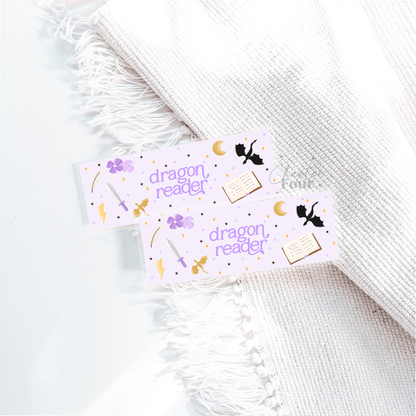 Two 'dragon reader' bookmarks on a white textured surface