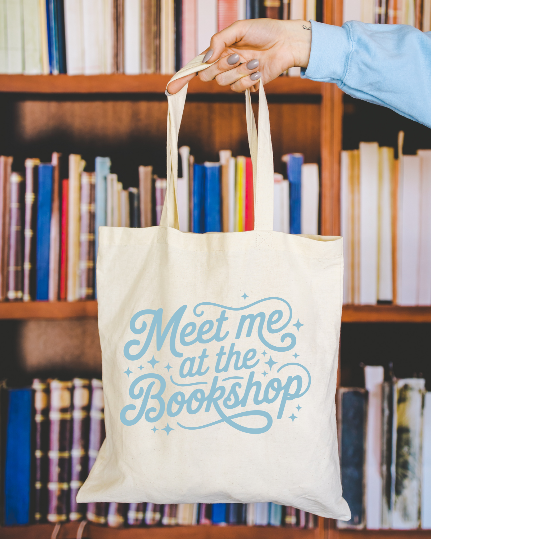 Tote bag with 'Meet me at the Bookshop' text held in front of a bookshelf.