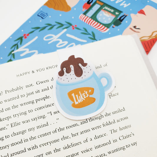 Magnetic Bookmark of a coffee cup with 'Luke's' logo on a book page