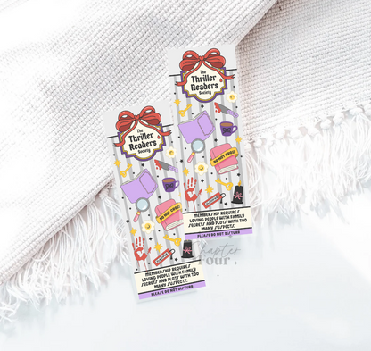 Colorful bookmarks with 'The Thriller Readers Society' design on a white textured background