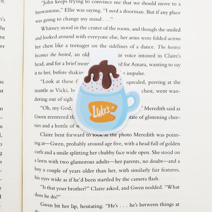 Illustration of a blue mug with 'Luke's' logo on a book page