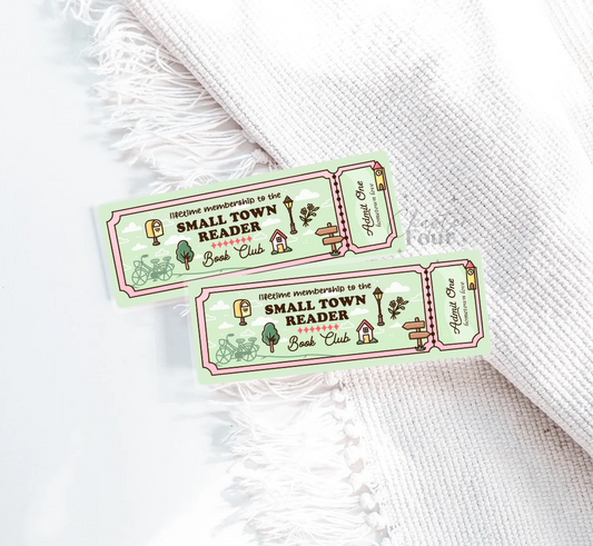 Two green and pink 'Small Town Reader Book Club' ticket bookmarks on a white textured surface.
