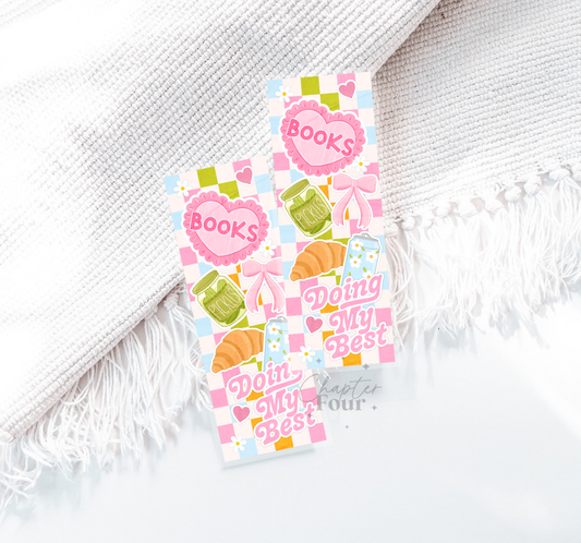 Decorative bookmark with 'Books Doing My Best' text on a white fabric background